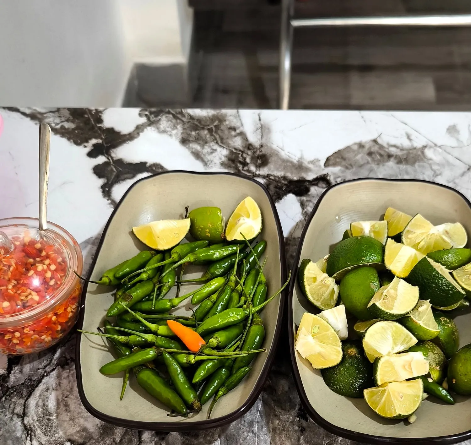 Fresh lime wedges and green bird’s-eye chilli
